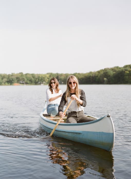two women in a canoe on a lake at Copestone, Idaho