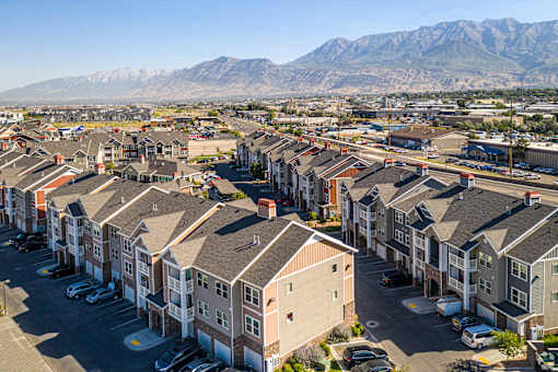 A row of houses with a mountain in the background at The Alloy at Geneva, Vineyard, 84058