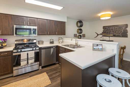 A kitchen with a stove top oven and a microwave.
