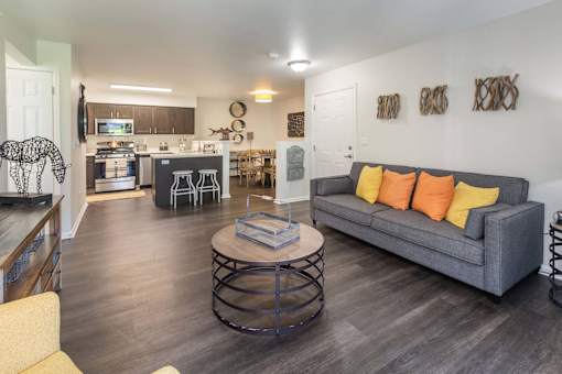 A living room with a grey couch and a coffee table.