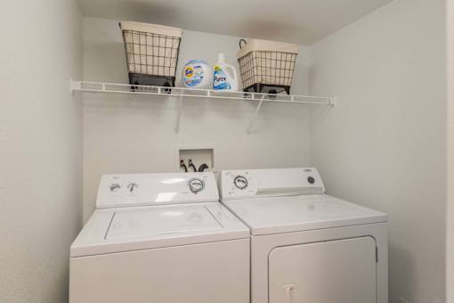A small laundry room with a washer and dryer.