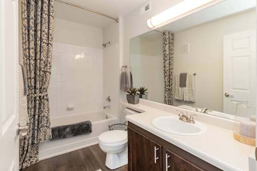 A bathroom with a white toilet, a white sink, and a white bathtub.