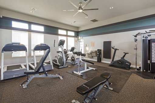 A spacious home gym with a variety of exercise equipment.