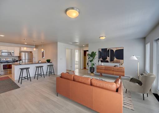 A modern living room with a bar area and a kitchen in the background at Four Points, Montana