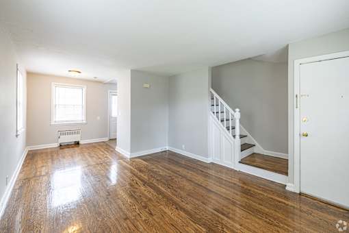 A room with a staircase and a window.