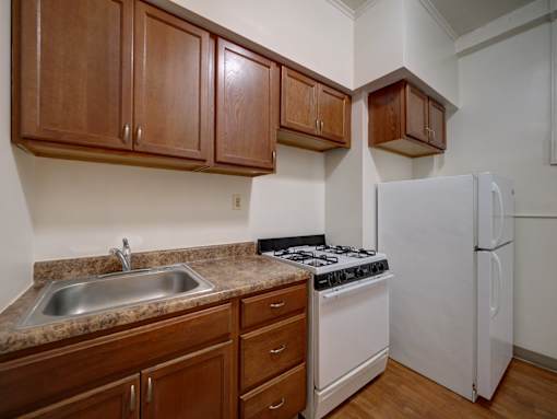 A kitchen with a white refrigerator and a white stove.
