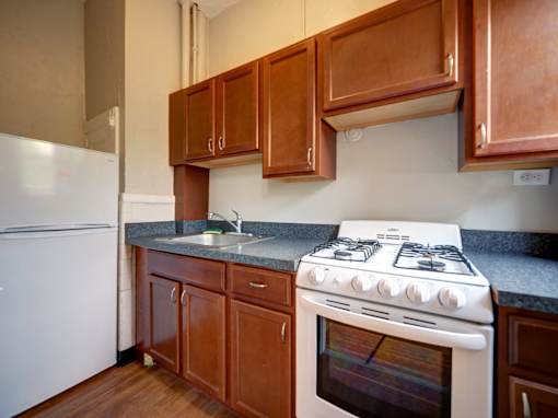 A white stove with a white oven in a kitchen.