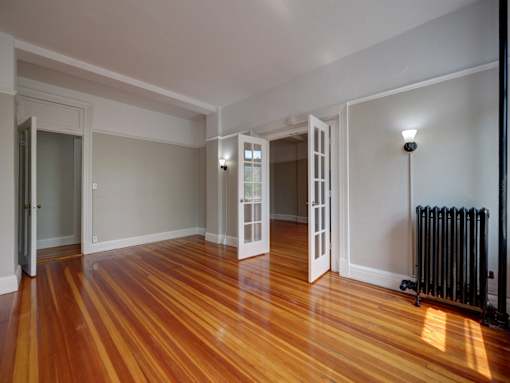 A room with wooden floors and white walls.