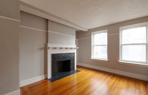 the living room of an empty house with a fireplace