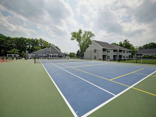 A tennis court with a blue and green surface and white lines.