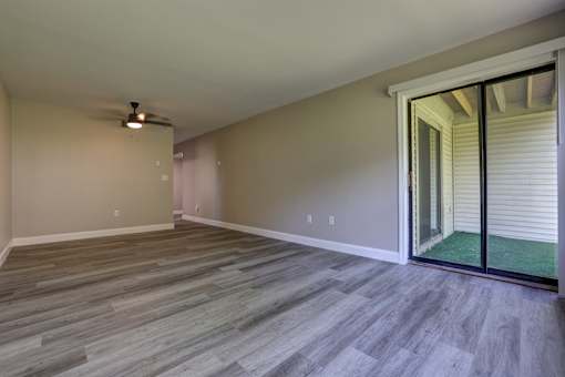 A room with a sliding glass door leading to a patio.