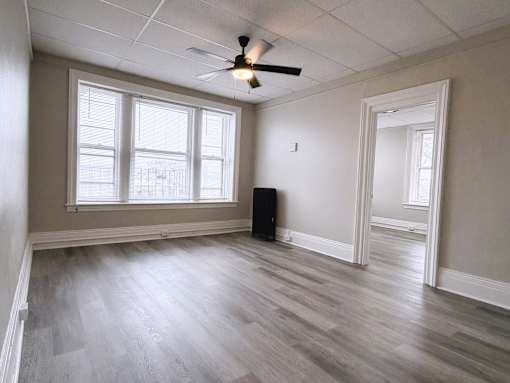 Room with ceiling fan and wooden floor at Willett Apartments, Albany, NY, 12210