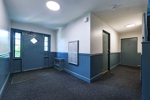A room with a blue door and a window.