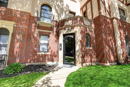 A red brick building with a black door and windows.