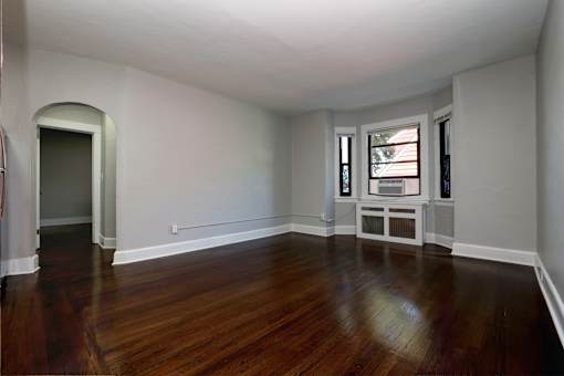 A room with wooden floors and white walls.