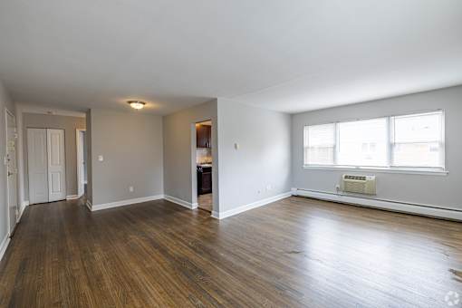 A room with wooden floors and a window.