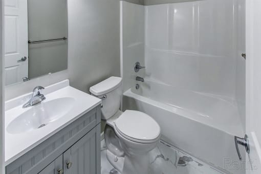 a white bathroom with a sink toilet and shower