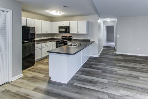a kitchen with white cabinets and a counter top