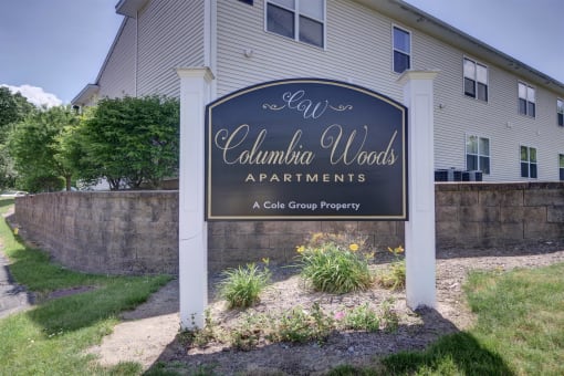 a sign apartments in front of a house
