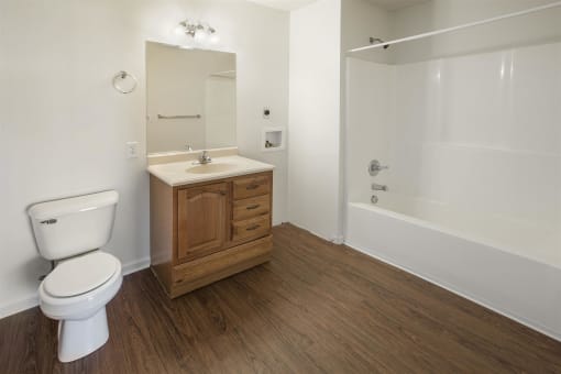 a bathroom with a toilet and a sink and a shower