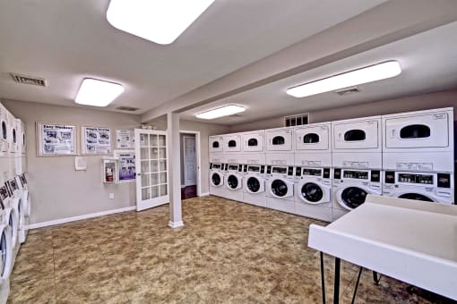 a washer and dryer area in a laundry room with stacks of washing machines