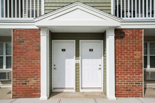 a pair of white doors on a red brick building