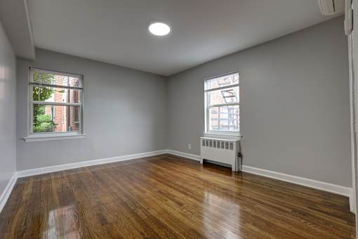 A room with wooden floors and a window.