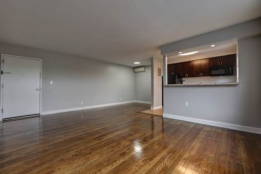A room with wooden floors and a white door.
