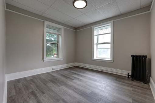 A room with a grey floor and a window.