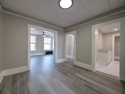 Unfurnished room with grey wooden floor at Willett Apartments, Albany, New York
