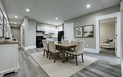 A dining room with a table set for four.