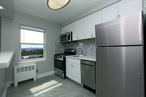A kitchen with a window overlooking a body of water.