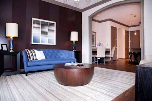 a living room with a blue couch and a coffee table