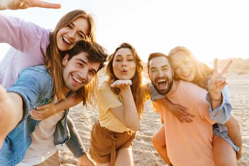 A group of friends are having fun on the beach.