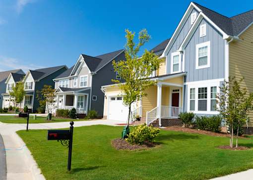 A row of houses with a blue sky in the background.