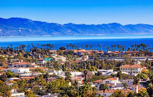 a city with a lake and mountains in the background