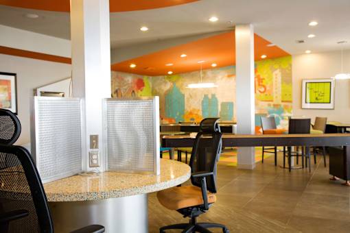 a dining area with tables and chairs and a mural on the wall