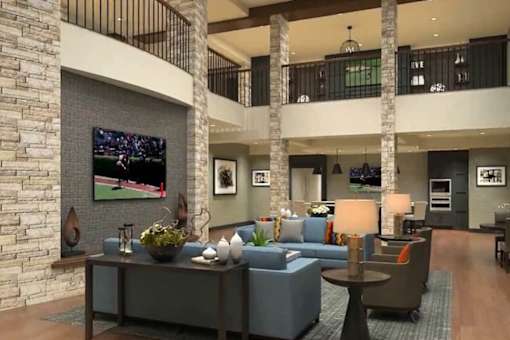 a lobby with couches a table and a television
