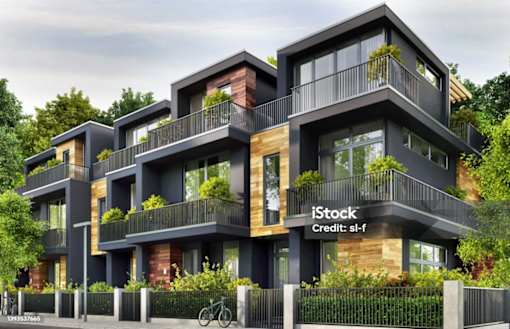 A modern multi-story residential building with balconies and windows.