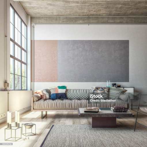 A modern living room with a grey sofa and a grey rug.