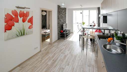 a small apartment with a kitchen and a living room