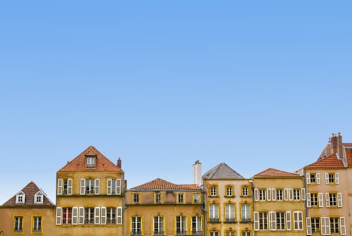 a row of houses against a blue sky