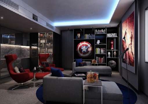 a living room with couches and chairs and a wall filled with avengers artwork