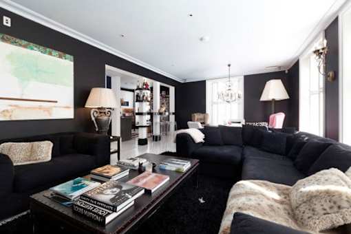 a living room with black couches and a coffee table