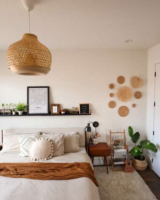 a bedroom with a bed and several hats on the wall