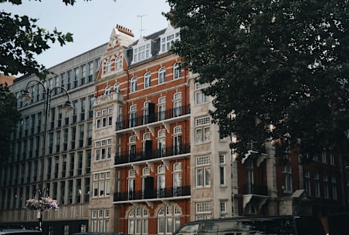 a city street with tall buildings and trees