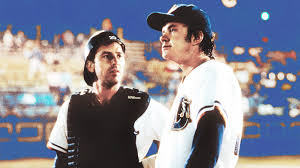 two baseball players standing next to each other on a field