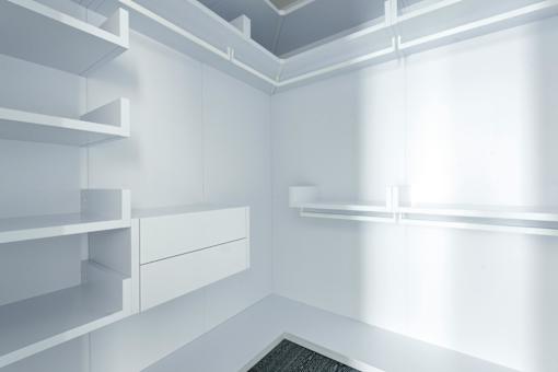 A white pantry with shelves and drawers.