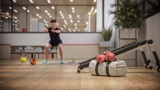 a man exercising in a gym with weights and a reformer