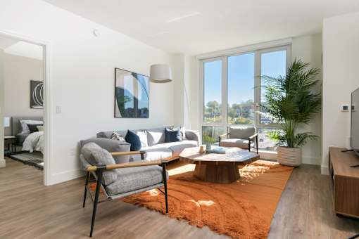 a living room with a couch and a table and a window